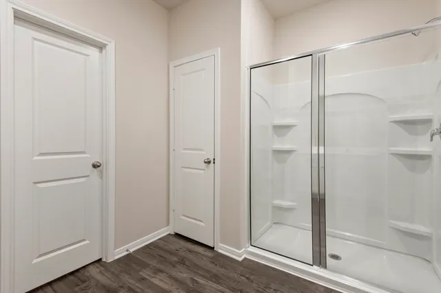 a bathroom with a glass shower door