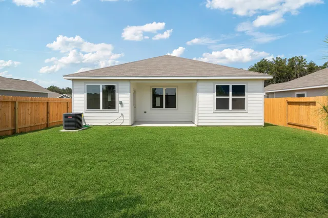 a view of a house with backyard and a garden