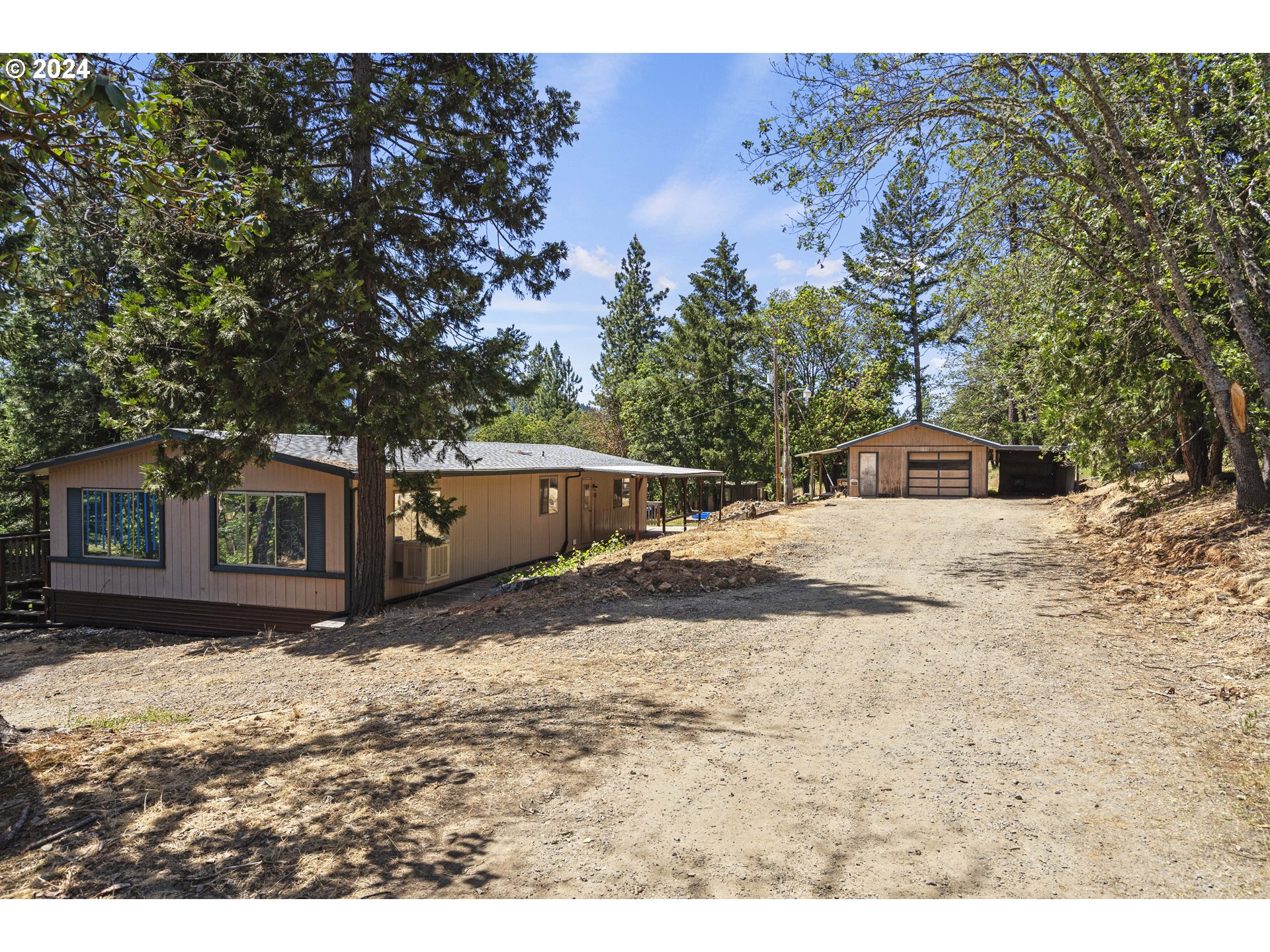 a view of a yard covered with snow in front of house