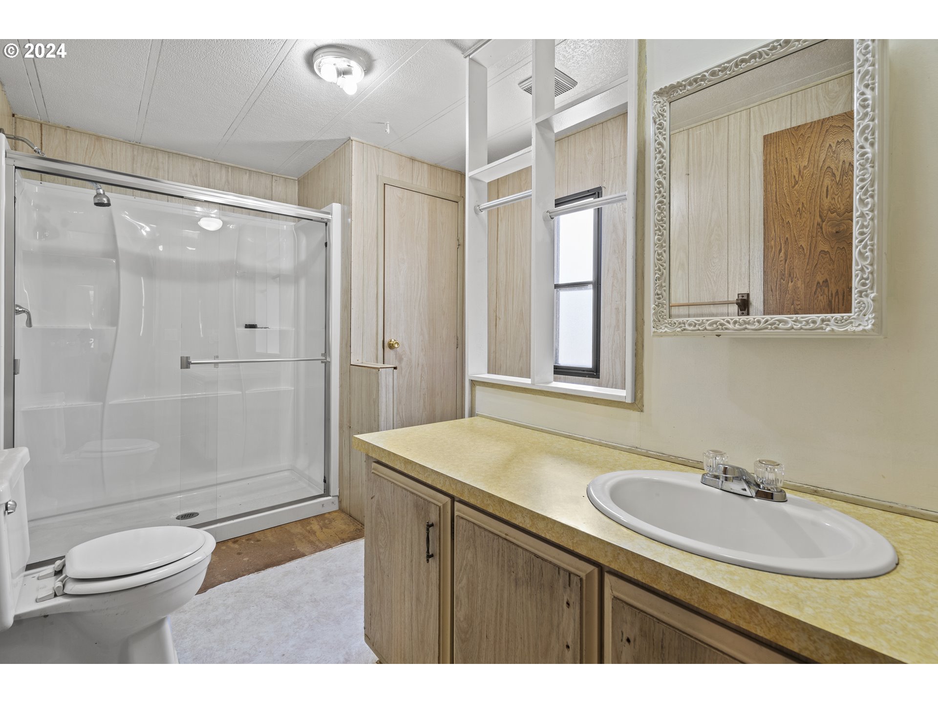 10244 North Applegate Road Grants Pass, OR 97527 - Photo 11 of 24 a bathroom with a sink toilet a mirror and shower
