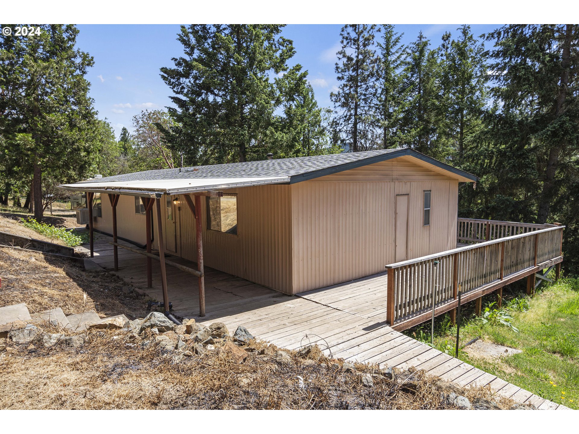 10244 North Applegate Road Grants Pass, OR 97527 - Photo 16 of 24 a backyard of a house with wooden deck and stairs