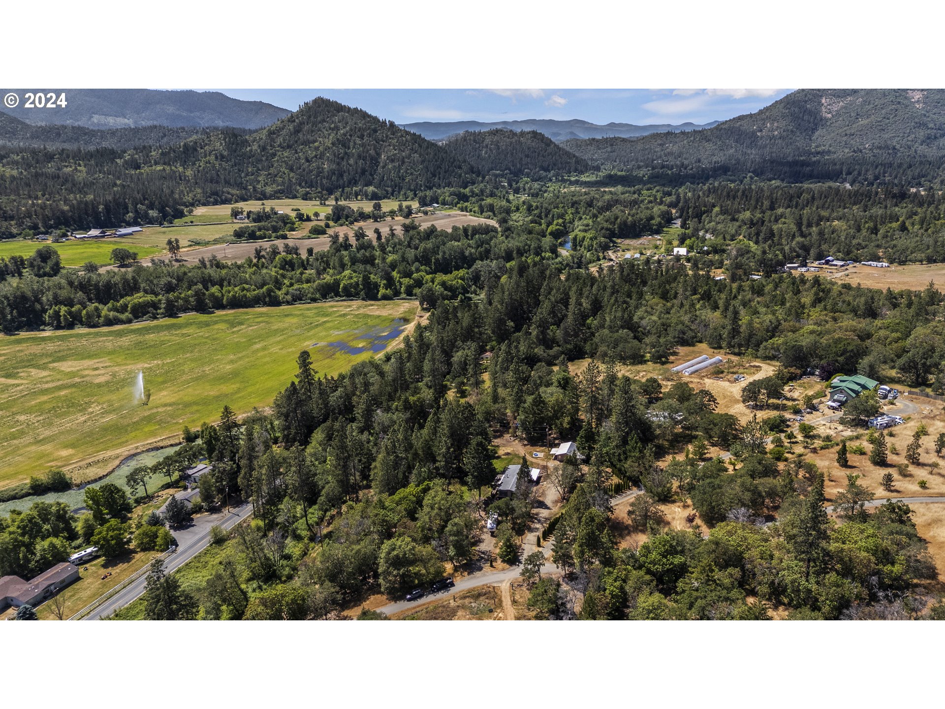 10244 North Applegate Road Grants Pass, OR 97527 - Photo 21 of 24 a view of a city with mountains in the background