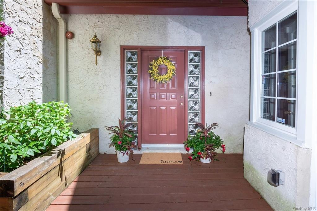 a view of front door of house with potted plant