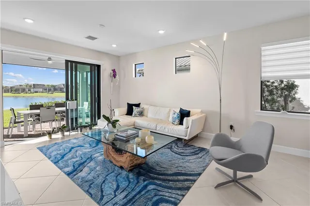 a living room with furniture and large windows