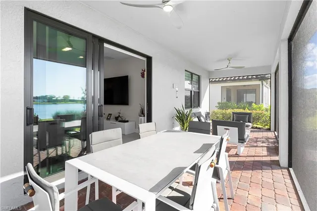 a living room with a floor to ceiling window and wooden floor