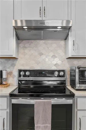 a stove top oven sitting inside of a kitchen