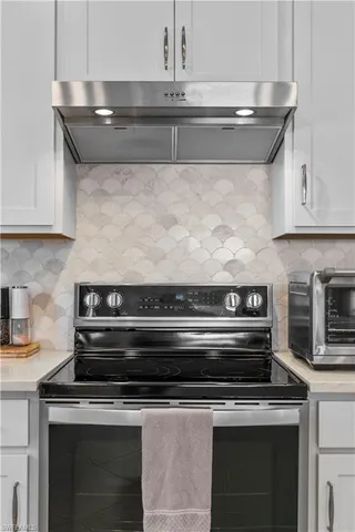 a stove top oven sitting inside of a kitchen