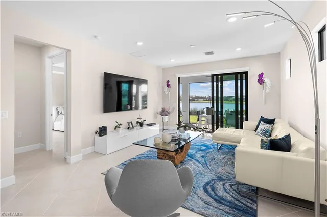 a living room with furniture large window and flat screen tv