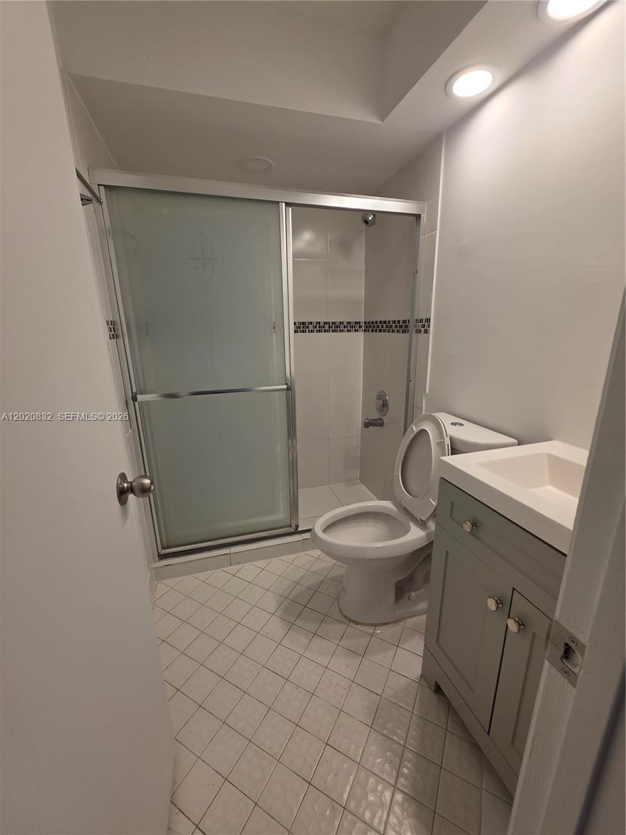 15240 Southwest 45th Terrace, Unit 54F Miami, FL 33185 - Photo 19 of 48 a white toilet sitting next to a bathroom sink
