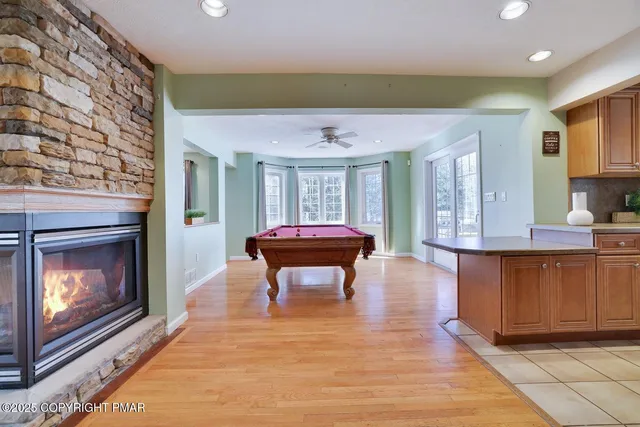a living room with furniture a fireplace and a table