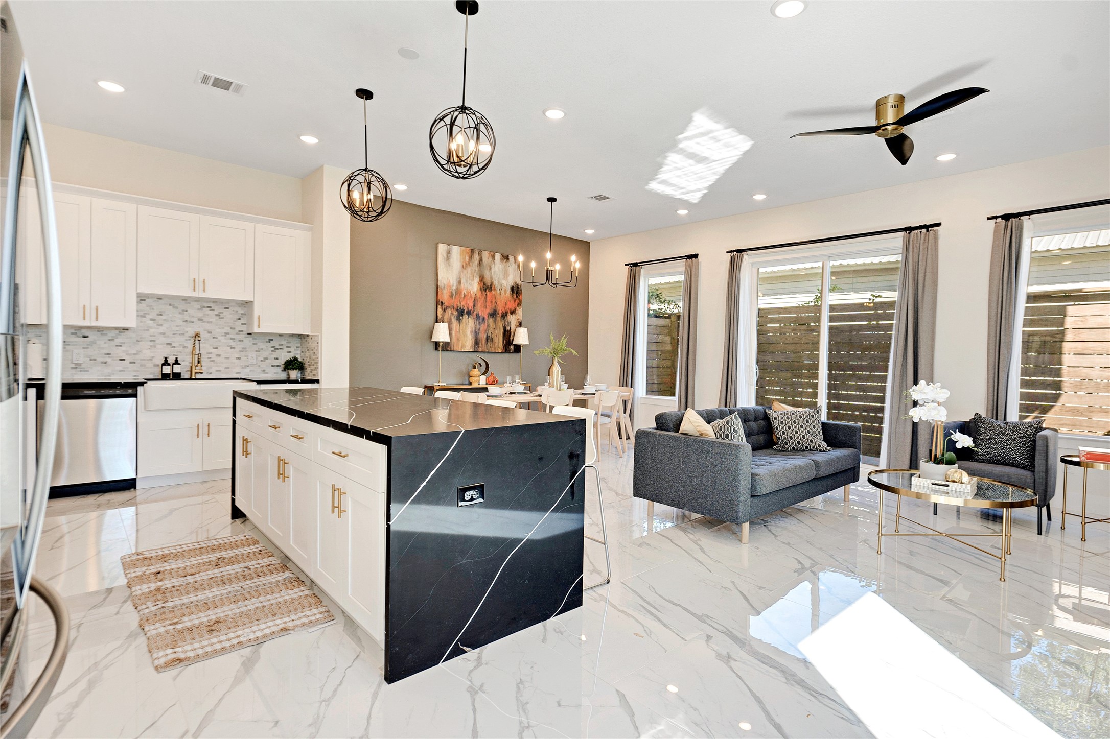 5908 St Augustine Street, Unit C Houston, TX 77021 - Photo 13 of 33 a large living room with stainless steel appliances kitchen island granite countertop furniture and a large window