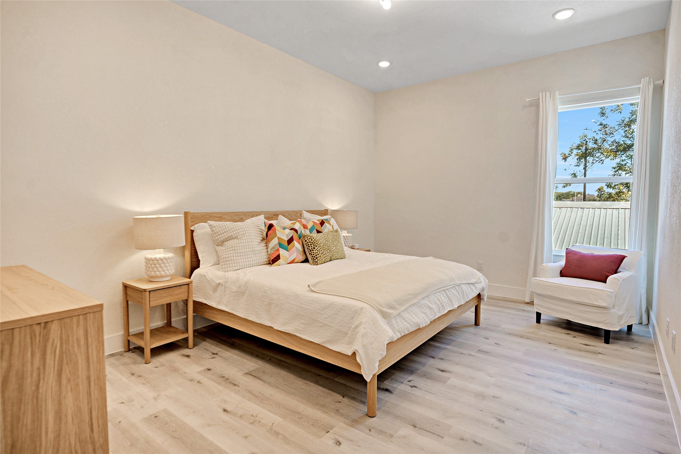 5908 St Augustine Street, Unit C Houston, TX 77021 - Photo 16 of 33 a bedroom with a bed and a chair