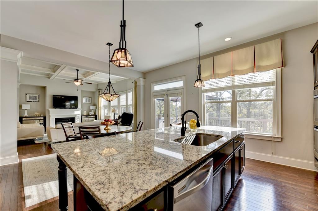 5930 Caveat Court Suwanee, GA 30024 - Photo 30 of 98 a kitchen with granite countertop a sink a counter top space and living room view