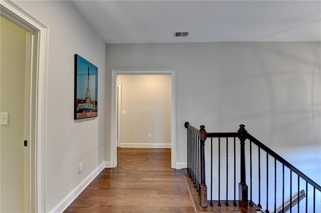 5930 Caveat Court Suwanee, GA 30024 - Photo 35 of 98 a view of a hallway with wooden floor and stairs