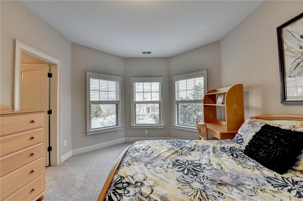 5930 Caveat Court Suwanee, GA 30024 - Photo 42 of 98 a bedroom with a bed wooden floor and window