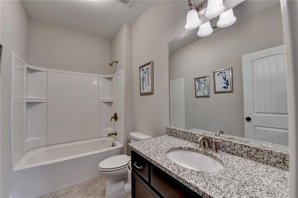 5930 Caveat Court Suwanee, GA 30024 - Photo 48 of 98 a bathroom with a granite countertop sink a toilet and shower