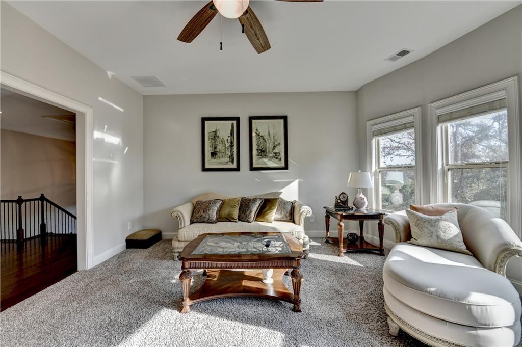5930 Caveat Court Suwanee, GA 30024 - Photo 52 of 98 a living room with furniture and a large window