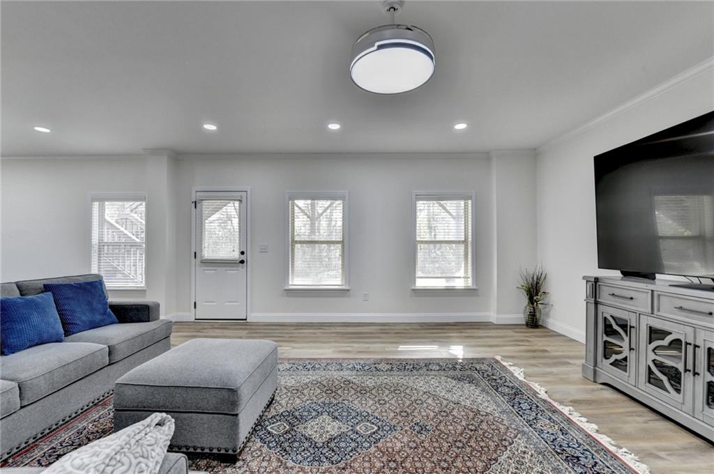 5930 Caveat Court Suwanee, GA 30024 - Photo 70 of 98 a living room with furniture and a flat screen tv