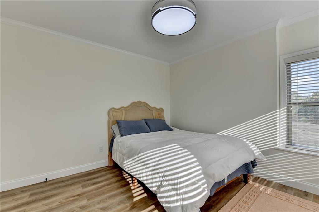 5930 Caveat Court Suwanee, GA 30024 - Photo 73 of 98 a bedroom with a bed and wooden floor