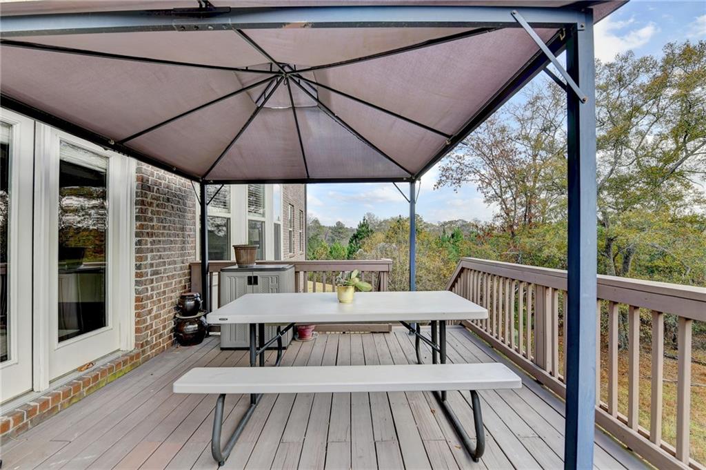 5930 Caveat Court Suwanee, GA 30024 - Photo 76 of 98 a view of a patio with a table chairs under an umbrella