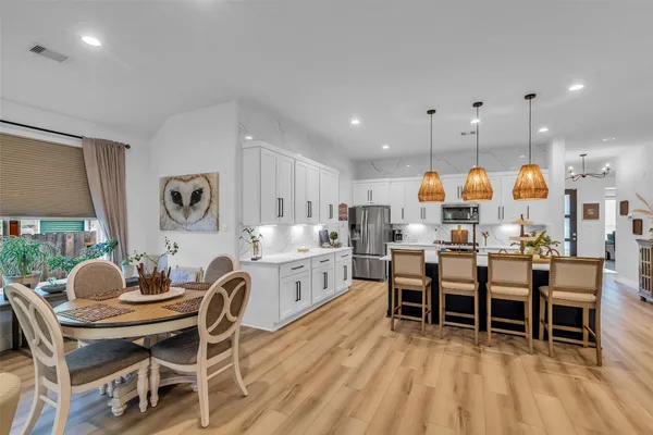 a view of a dining room with furniture and wooden floor