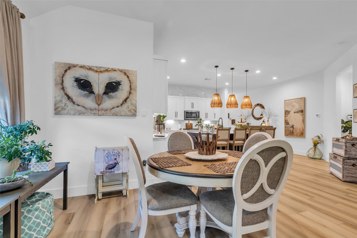 307 Springfield Terrace Drive Conroe, TX 77304 - Photo 12 of 30 a view of a dining room with furniture and wooden floor
