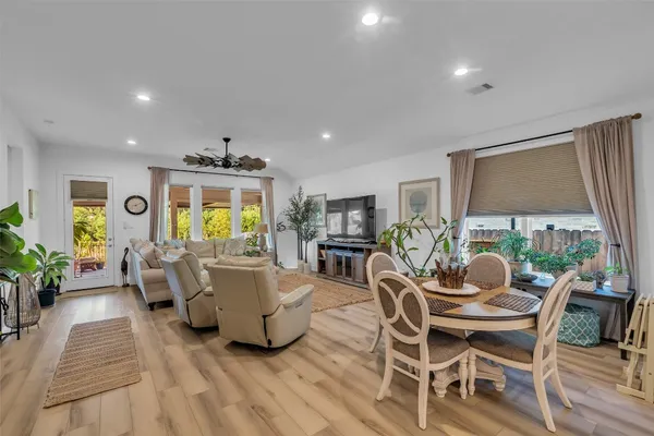 a living room with furniture a window and a flat screen tv