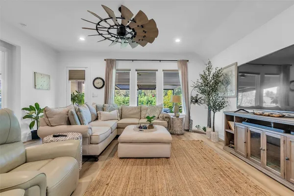 a living room with furniture and a wooden floor
