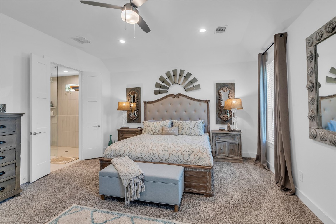 307 Springfield Terrace Drive Conroe, TX 77304 - Photo 17 of 30 a bedroom with a bed and a chandelier