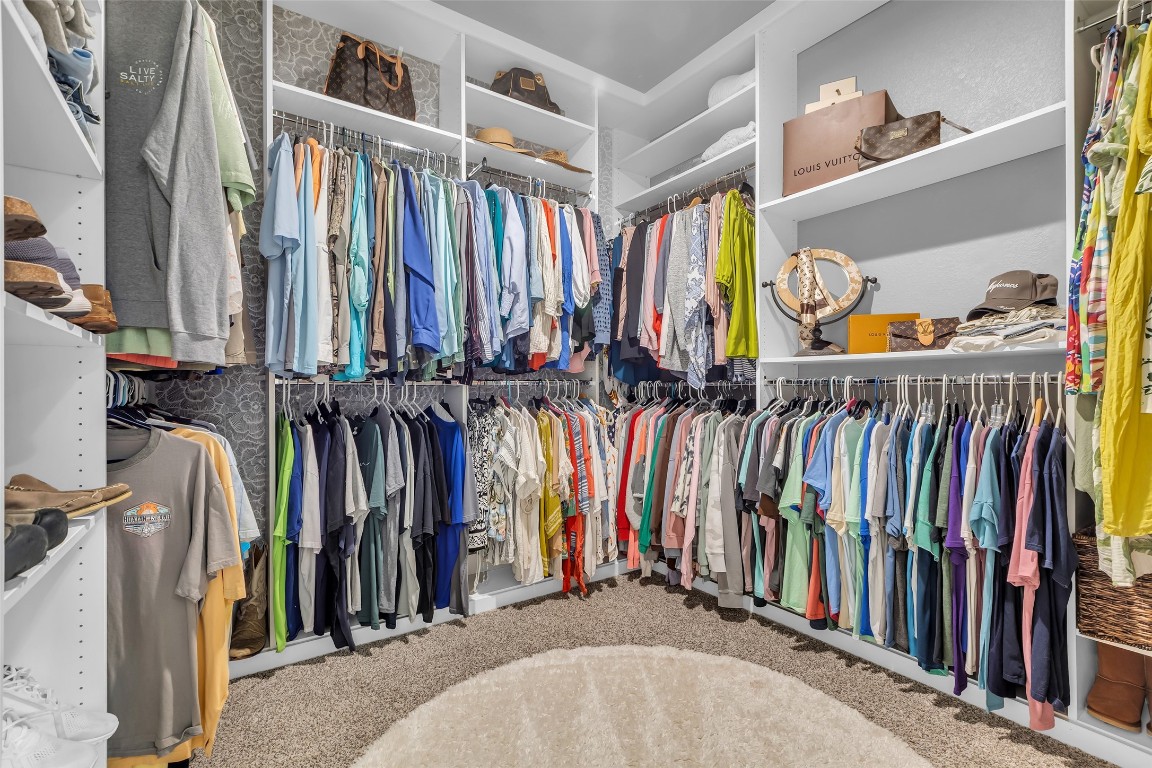 307 Springfield Terrace Drive Conroe, TX 77304 - Photo 18 of 30 a view of walk in closet with clothes and shoes