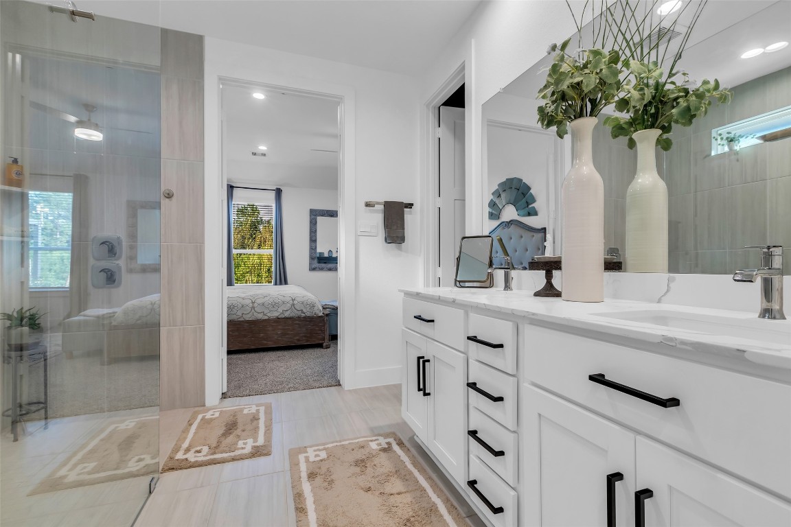307 Springfield Terrace Drive Conroe, TX 77304 - Photo 19 of 30 a spacious en suite bathroom with a double sink and mirror