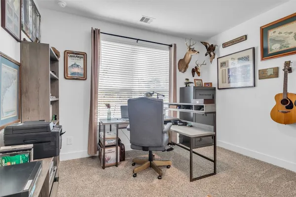 a workspace with furniture and a potted plant