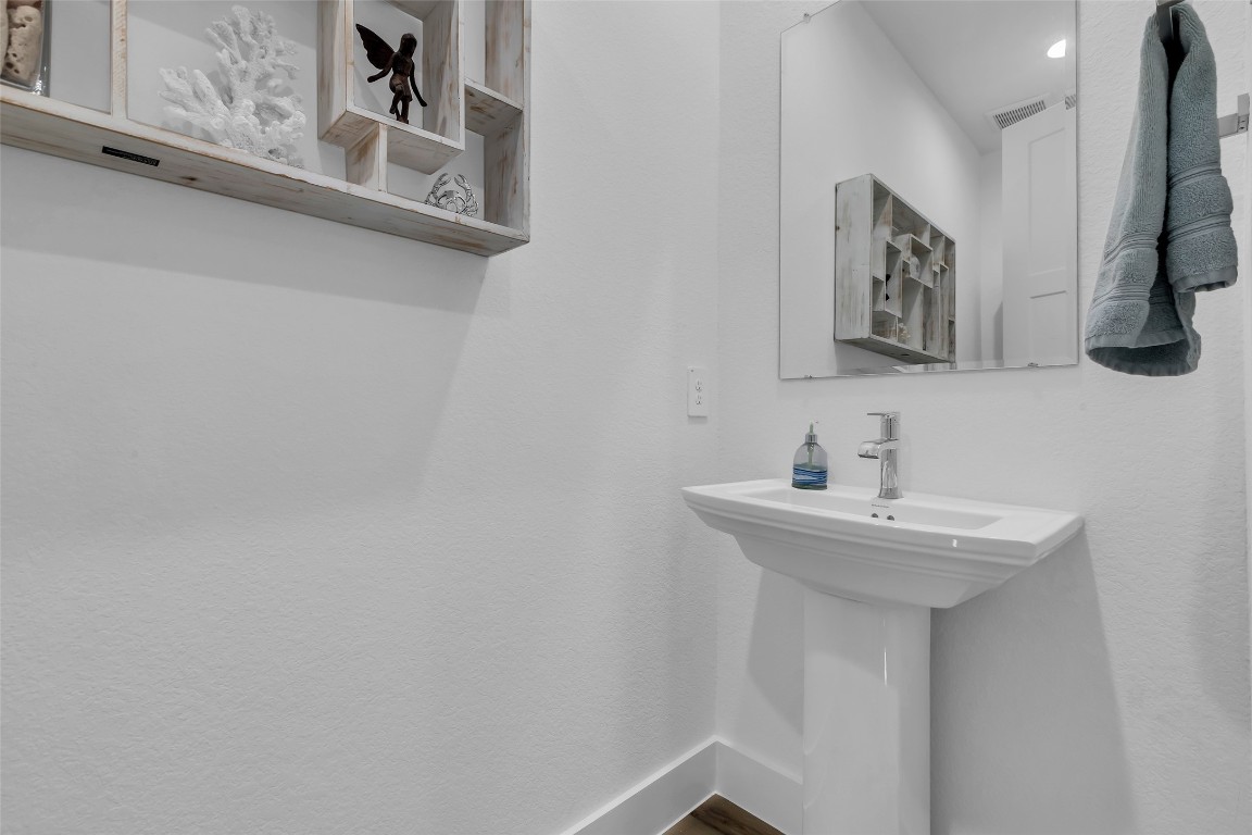 307 Springfield Terrace Drive Conroe, TX 77304 - Photo 24 of 30 a bathroom with a sink and a mirror