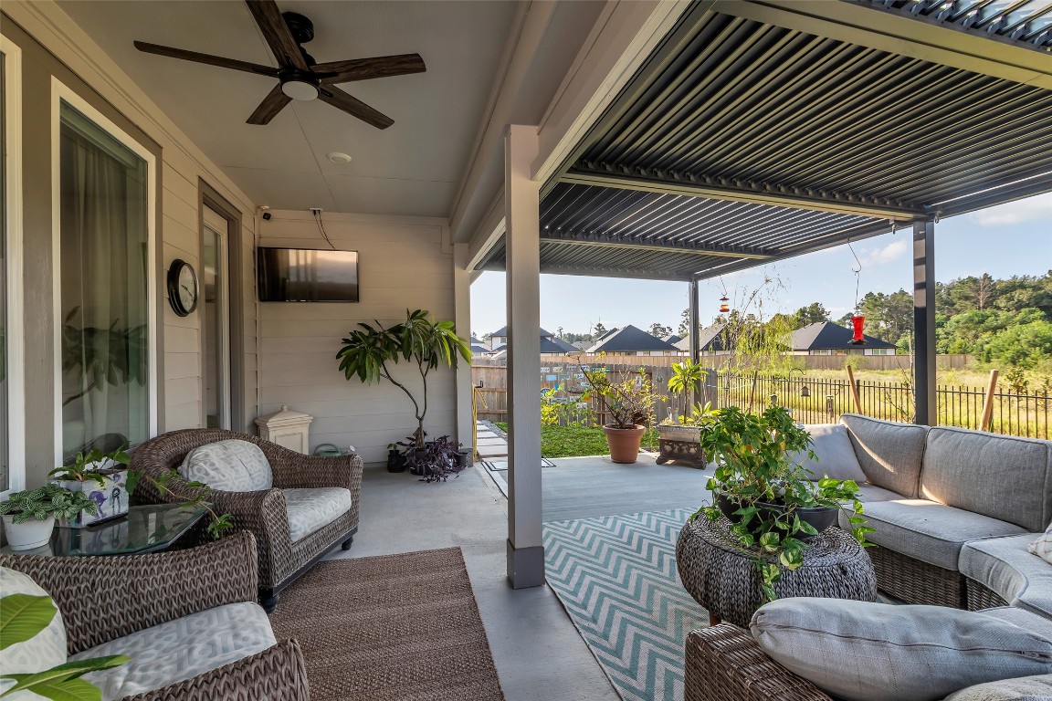 307 Springfield Terrace Drive Conroe, TX 77304 - Photo 27 of 30 a outdoor living space with furniture and a potted plant