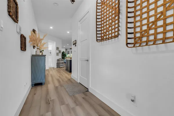 a view of a kitchen with kitchen island a stove a sink a center island and couches