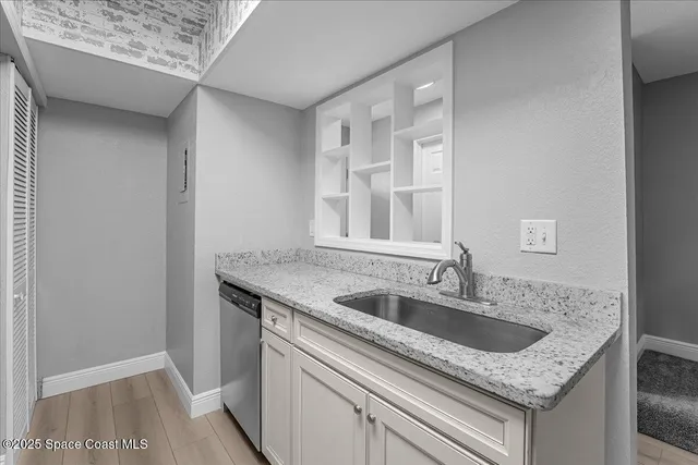 a kitchen with granite countertop a sink and a window