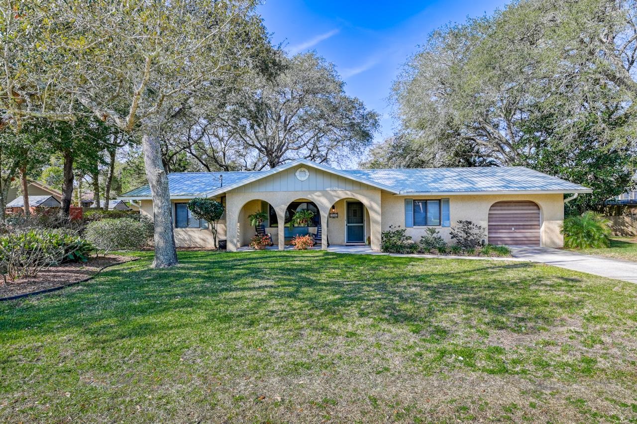 336 Lobelia Road St. Augustine, FL 32086 - Photo 1 of 46 a front view of a house with garden