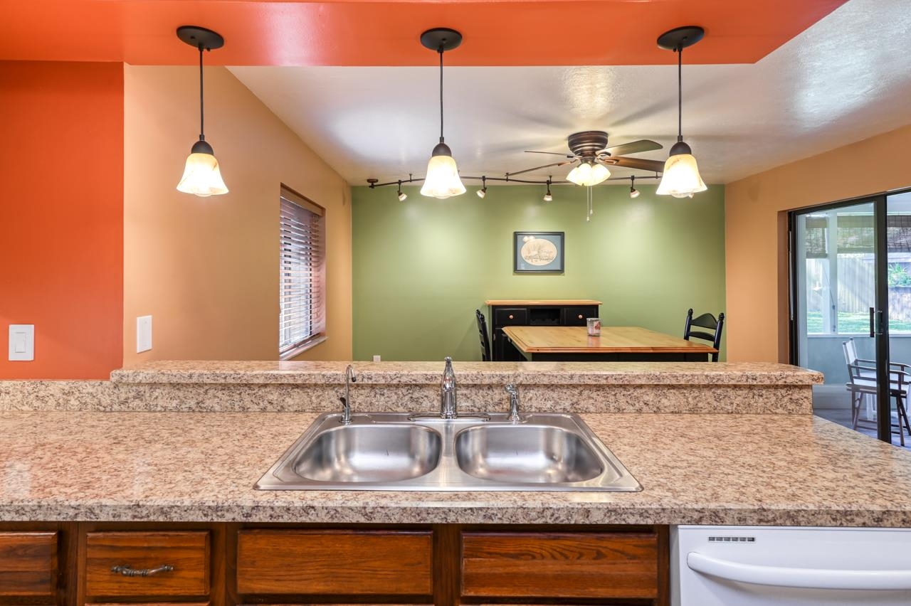 336 Lobelia Road St. Augustine, FL 32086 - Photo 11 of 46 a kitchen with a granite countertop sink and a wooden floor