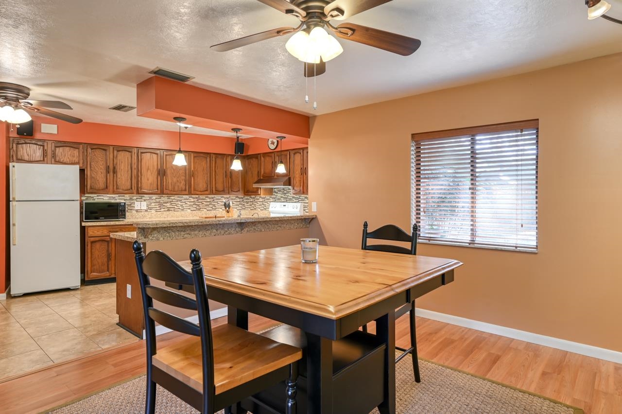 336 Lobelia Road St. Augustine, FL 32086 - Photo 13 of 46 a view of a dining room with furniture and wooden floor