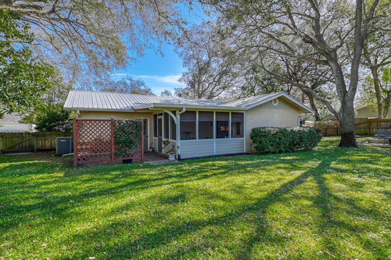 336 Lobelia Road St. Augustine, FL 32086 - Photo 20 of 46 a view of a house with a yard and sitting area