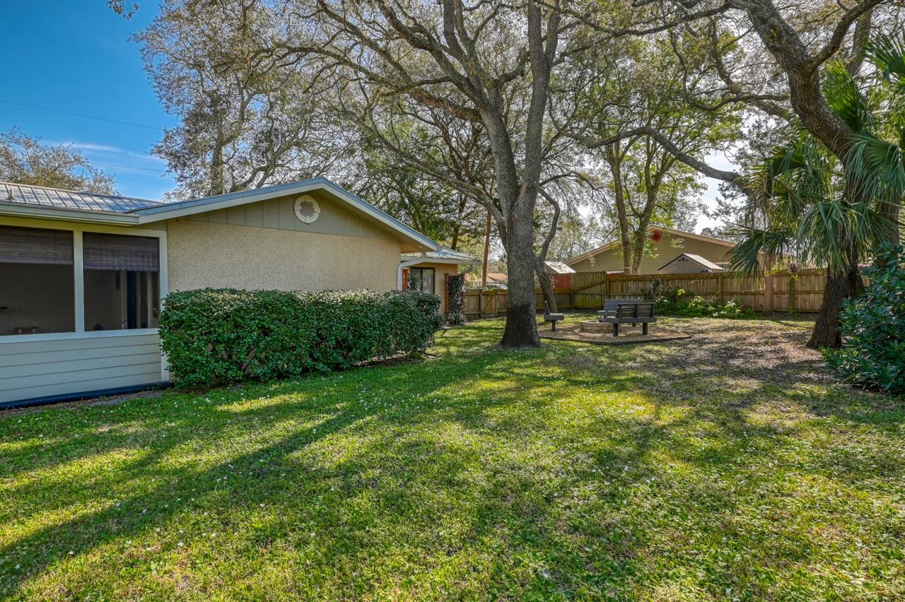 336 Lobelia Road St. Augustine, FL 32086 - Photo 21 of 46 a backyard of a house with table and chairs