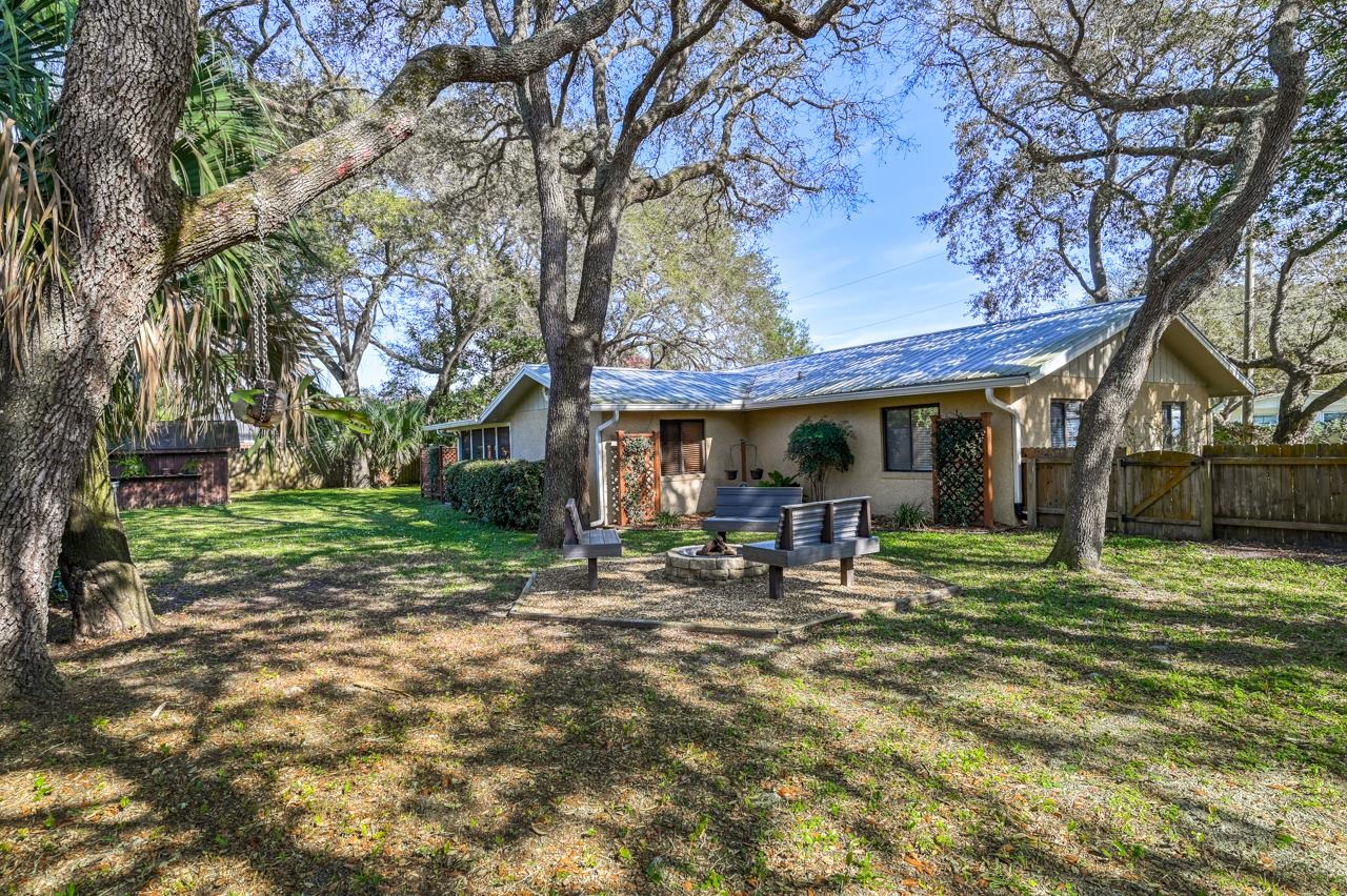 336 Lobelia Road St. Augustine, FL 32086 - Photo 23 of 46 a front view of house with a garden and trees