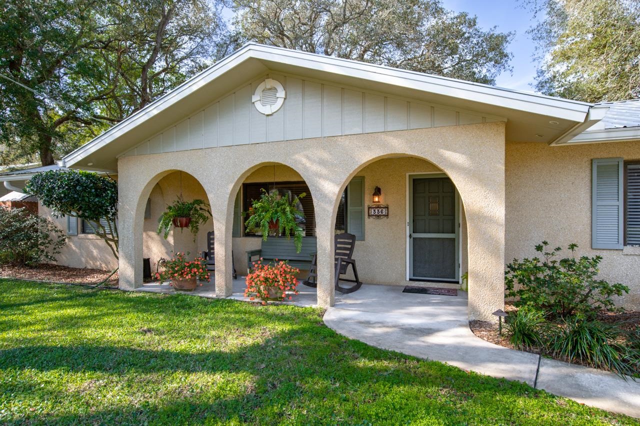 336 Lobelia Road St. Augustine, FL 32086 - Photo 3 of 46 a front view of a house with garden