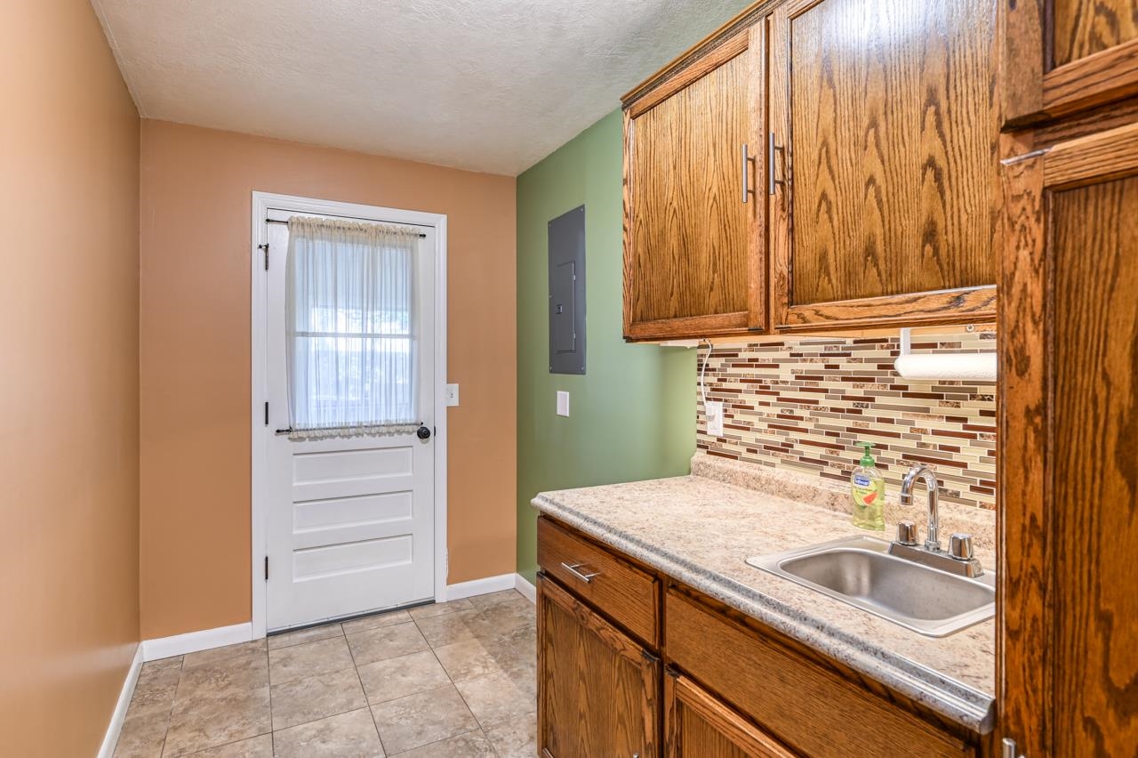 336 Lobelia Road St. Augustine, FL 32086 - Photo 35 of 46 a bathroom with a granite countertop sink and a mirror
