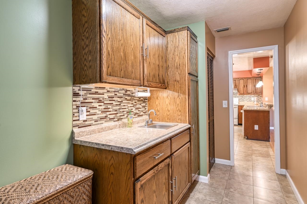 336 Lobelia Road St. Augustine, FL 32086 - Photo 36 of 46 a bathroom with a granite countertop sink and a mirror