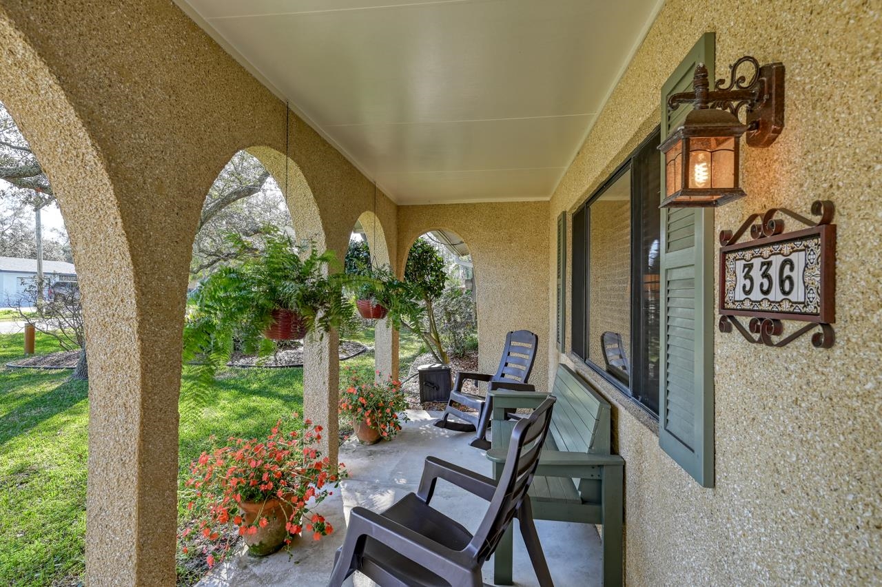 336 Lobelia Road St. Augustine, FL 32086 - Photo 4 of 46 a view of a porch with chairs and backyard