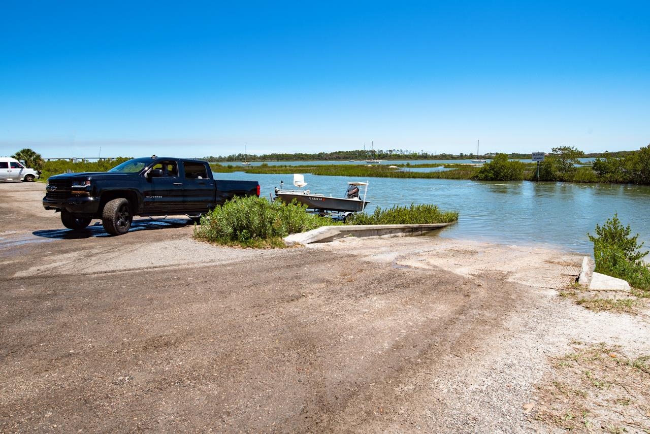 336 Lobelia Road St. Augustine, FL 32086 - Photo 42 of 46 a view of a lake with a car parked