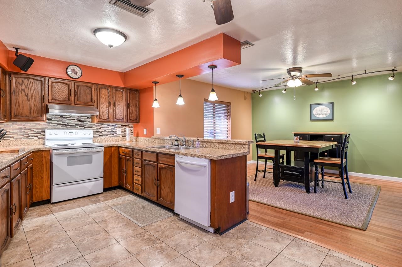 336 Lobelia Road St. Augustine, FL 32086 - Photo 9 of 46 a kitchen with stainless steel appliances granite countertop a sink counter space and a view of living room