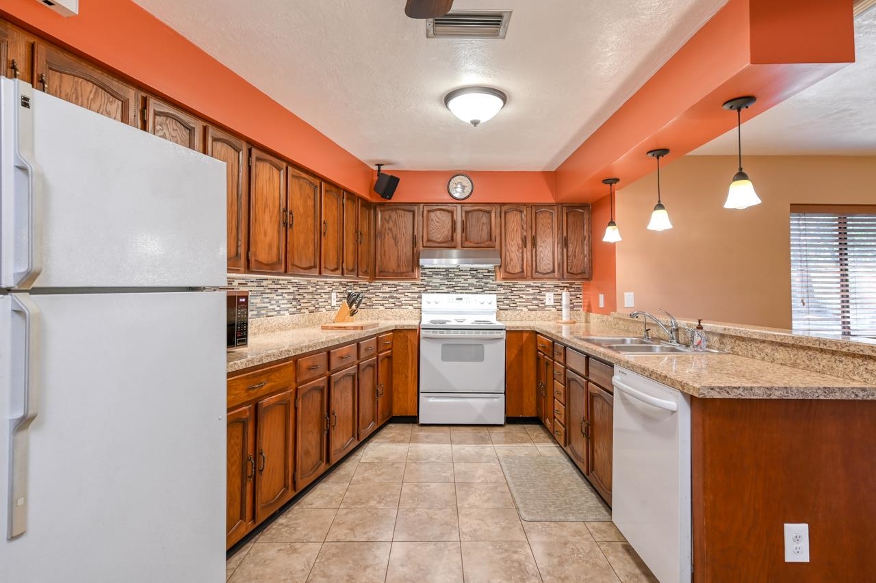 336 Lobelia Road St. Augustine, FL 32086 - Photo 10 of 46 a kitchen with stainless steel appliances granite countertop a sink stove and refrigerator