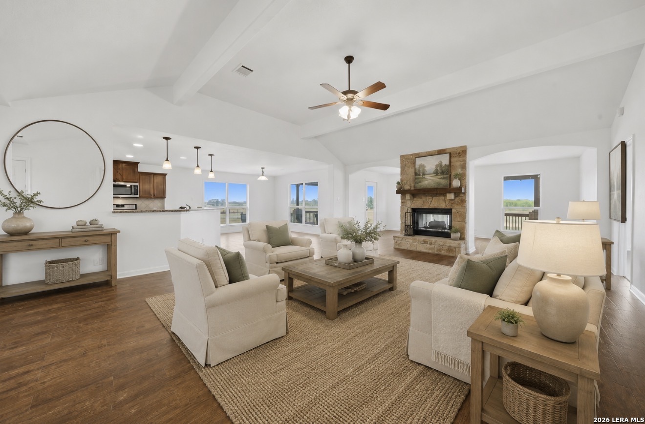 12897 La Vernia Road St. Hedwig, TX 78152 - Photo 8 of 34 a living room with furniture a fireplace and a flat screen tv